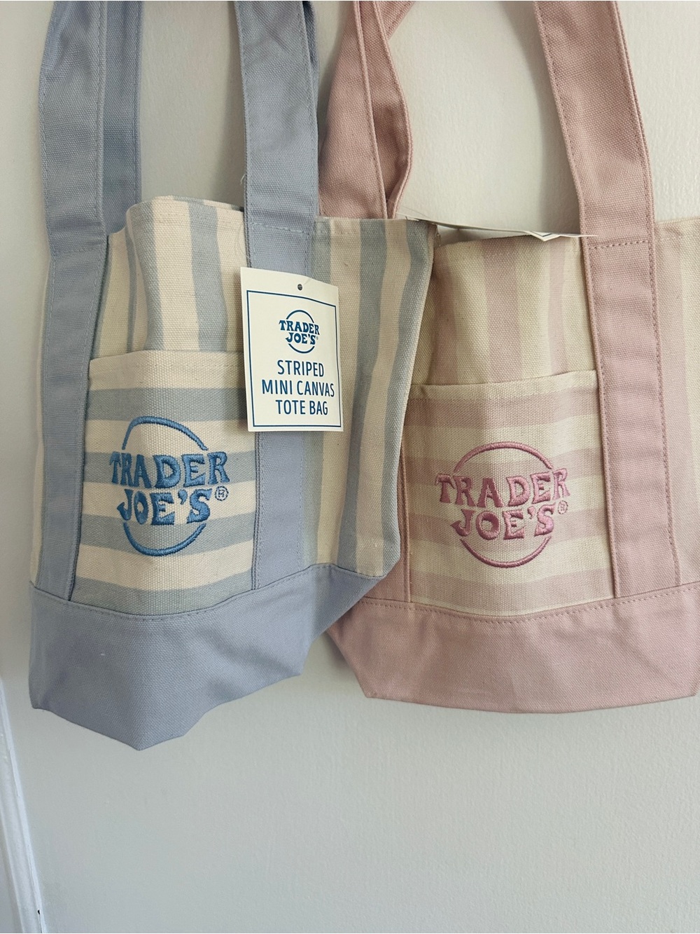 2 Trader Joe’s striped mini totes 
1 blue 1 pink 
Both NWT